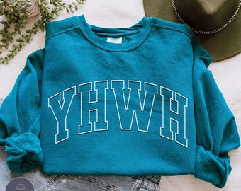 May include: A teal blue sweatshirt with the word "YHWH" in white outlined letters in an arch across the front.