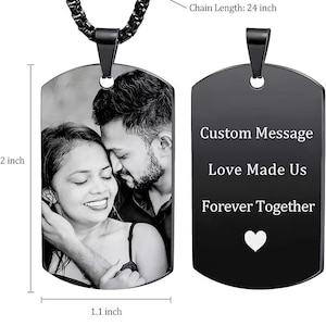 May include: Black stainless steel dog tag necklace with a 24 inch chain. The front side features a laser engraved image of a couple in black and white. The back side features laser engraved text that reads "Custom Message Love Made Us Forever Together" with a white heart symbol.