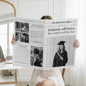 May include: A black and white newspaper titled "The Graduation Post" with the headline "Definitely eaRNed it: She's ready to call the shots!" The newspaper features photos of a graduate in a cap and gown.