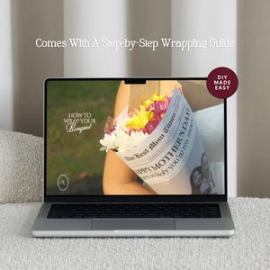 May include: A laptop displays a floral bouquet wrapped in newspaper, with text that reads "Happy Mother's Day". The screen also shows "How to Wrap Your Bouquet" and "Comes With A Step-by-Step Wrapping Guide". A "DIY Made Easy" sticker is in the corner.