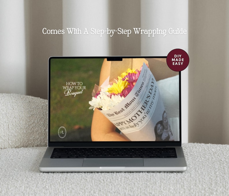 May include: A laptop displays a floral bouquet wrapped in newspaper, with text that reads "Happy Mother's Day". The screen also shows "How to Wrap Your Bouquet" and "Comes With A Step-by-Step Wrapping Guide". A "DIY Made Easy" sticker is in the corner.