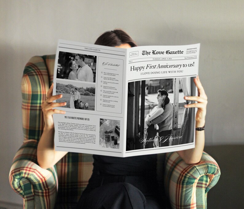 May include: A black and white newspaper with the headline "The Love Gazette" and the text "Happy First Anniversary to us! I LOVE DOING LIFE WITH YOU". The newspaper features photos of a couple.