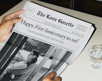 May include: A black and white photo of a couple in a newspaper with the headline "Happy First Anniversary to us! I LOVE DOING LIFE WITH YOU". The newspaper is titled "The Love Gazette" and is dated Tuesday, April 9, 2024.