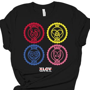May include: Black t-shirt featuring four circular designs with cartoon animal graphics and text. Each design has a different color: red, yellow, blue, and pink. The text "XLCL" is at the bottom, with additional text below it.