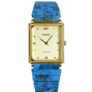 May include: A gold-tone square watch with a white face and diamond hour markers. The watch has a blue turquoise band.