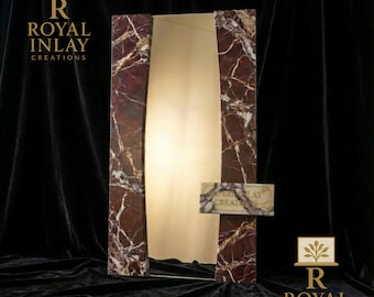 May include: A tall, rectangular mirror with a marble frame featuring burgundy and white veining. The mirror has a gold-colored interior and a small marble sign with the text "ROYAL INLAY CREATIONS". The logo "R ROYAL INLAY CREATIONS" is visible.