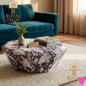 May include: A geometric coffee table with a white and purple marble top. The table is in front of a teal sofa and a cream-colored rug. A small vase with greenery and books are on the table. The table has the text "Royal Inlay Creations".