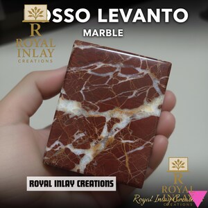 May include: A rectangular Rosso Levanto marble tile with a polished surface. The tile features a deep red base color with white and light brown veining. The text "MARBLE" and "ROYAL INLAY CREATIONS" are visible.