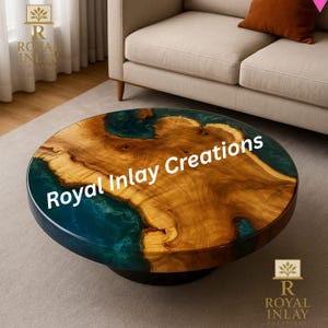 May include: Round coffee table with a wooden top featuring a natural wood grain design and a teal epoxy resin inlay. The table has a dark base and the text "Royal Inlay Creations" is visible on the top.
