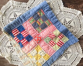 Vintage quilt cutter piece in vibrant colours red blues pinks