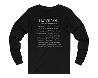 May include: Black long-sleeve t-shirt with white text that reads "I Love You" in different languages. The text includes the words "I love you" in English, French, German, Spanish, Italian, Portuguese, Dutch, Polish, Japanese, Arabic, Swahili, and Korean.