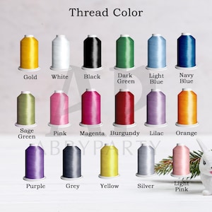 May include: A chart showing 15 different thread colors for embroidery. The colors are: gold, white, black, dark green, light blue, navy blue, sage green, pink, magenta, burgundy, lilac, orange, purple, grey, yellow, silver, and light pink.
