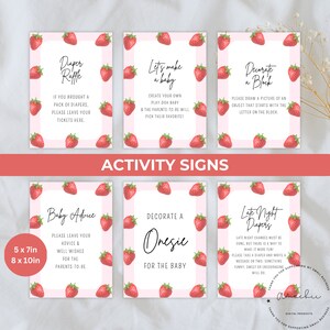 May include: A set of baby shower activity signs with a pink strawberry theme. Each sign has a white background with text and a strawberry border. The signs include prompts for diaper raffle, baby advice, and decorating a onesie.