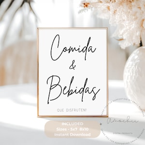 May include: A framed white sign with the words "Comida & Bebidas" in elegant black script. Below, it reads "QUE DISFRUTEN!" in Spanish. The sign is in a gold frame and includes size options and instant download information.