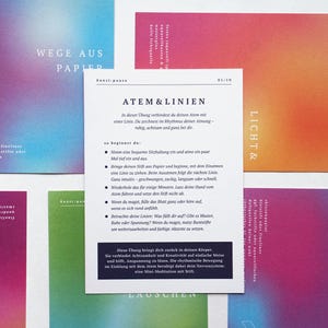 May include: A collection of colorful cards with gradient backgrounds in shades of pink, blue, green, and orange. A central card features text in German, with the title "ATEM & LINIEN". The cards are arranged on a white surface.