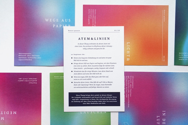 May include: A collection of colorful cards with gradient backgrounds in shades of pink, blue, green, and orange. A central card features text in German, with the title "ATEM & LINIEN". The cards are arranged on a white surface.