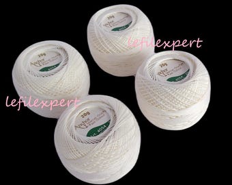 May include: Four white balls of Anchor Mercer Crochet Fast Colour yarn, each weighing 20 grams. The yarn is labeled with the brand name, weight, and color number 4054.