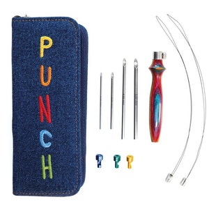 May include: A denim blue punch needle kit with the word "PUNCH" embroidered in colorful letters on the front of the zippered case. The kit includes needles, a wooden handle, wire threaders, and three metal needle tips.