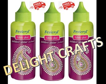 May include: Three bottles of Fevicryl fabric glue. The bottles are purple with a green cap and a label that reads "fabric glue". The label also features a decorative paisley design. The text "DELIGHT CRAFTS" is overlaid on the image.