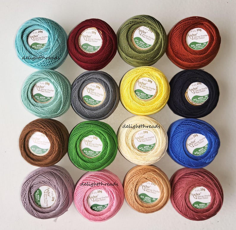May include: A collection of colorful Anchor crochet cotton thread balls, each labeled with "20g" and "Anchor." The assortment includes shades of teal, burgundy, olive green, orange, mint, gray, yellow, black, brown, green, cream, blue, lavender, pink, and peach.