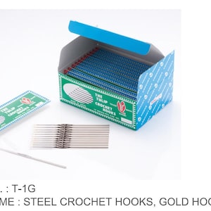 May include: A box of steel crochet hooks with gold hook points. The box is blue and green with the text "THE TULIP CROCHET HOOKS". Several individual hooks are displayed, along with a package of hooks.