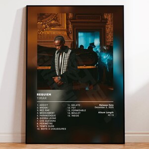 May include: A framed poster featuring the album "Requiem" by Timar. The image shows a man in a black jacket with a white and black patterned design. The poster includes a tracklist, release date, and album length.