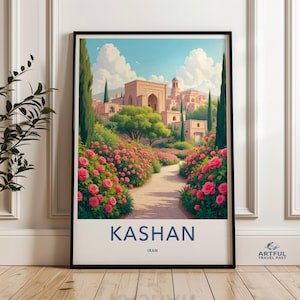 May include: Framed art print featuring a scenic view of Kashan, Iran. The artwork depicts a pathway lined with vibrant pink rose bushes leading to a traditional Middle Eastern city. The sky is a bright blue with fluffy white clouds. The text "KASHAN, IRAN" is at the bottom.