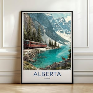 May include: A vertical wall art print featuring a red train traveling along a turquoise lake beneath snow-capped mountains and evergreen trees. A deer stands on a rocky shore in the foreground. The text ALBERTA CANADA is printed at the bottom.