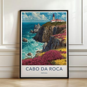 May include: A framed travel poster featuring a lighthouse on a cliff overlooking the ocean at Cabo da Roca, Portugal. The scene displays rocky cliffs, blue water, and vibrant patches of pink and yellow wildflowers under a cloudy blue sky.