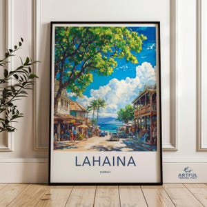 May include: A framed art print of Lahaina, Hawaii, featuring a vibrant street scene with shops, palm trees, and a view of the ocean under a bright blue sky. The print includes the text "LAHAINA" and "HAWAII".
