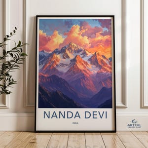 May include: A vintage travel poster featuring a scenic view of Nanda Devi, a mountain range in India. The poster has a blue and white color scheme with the text "Nanda Devi" and "India" printed in a bold, blue font.
