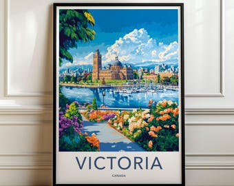 May include: A framed travel poster featuring a vibrant illustration of Victoria, Canada. The scene depicts a harbor with boats, the Parliament Buildings, and a foreground path lined with colorful flowers under a bright blue sky with clouds.
