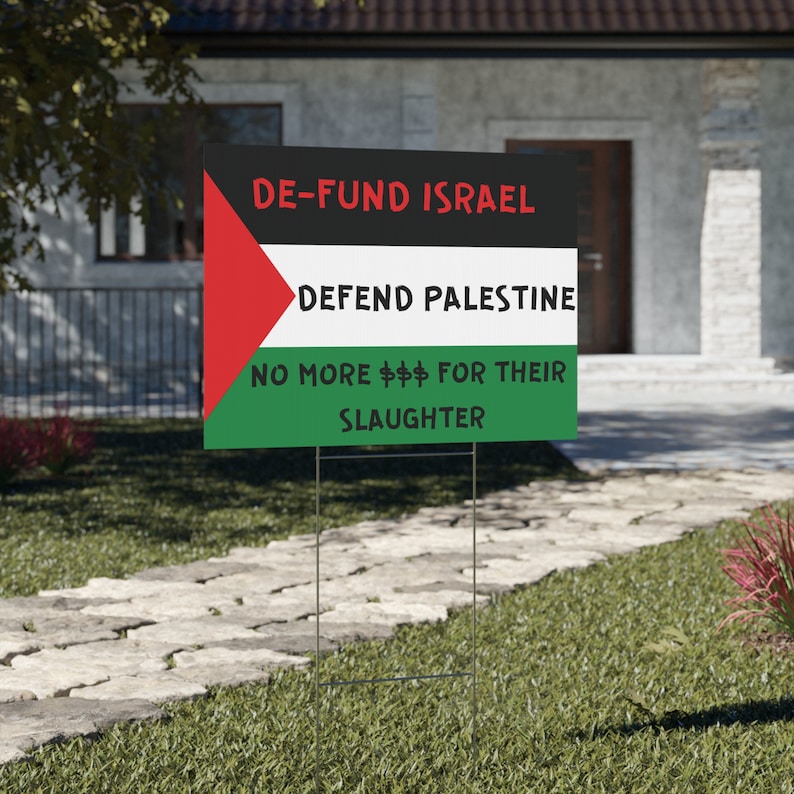 free Palestine yard sign or free Palestine protest sign that has the Palestinian flag and on it it says, Defund Israel, defend Palestine, no more money for their slaughter.