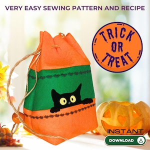 May include: Orange and green Halloween-themed drawstring bag with a black cat graphic. The bag has a green center section with a black cat peeking out. The bag is next to a carved pumpkin and a circular orange sign that says "Trick or Treat".