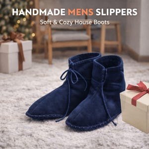 May include: A pair of navy blue house boots with laces, displayed on a white rug. The boots are handmade and have a soft, cozy appearance. The text "HANDMADE MENS SLIPPERS" and "Soft & Cozy House Boots" is visible in the image.