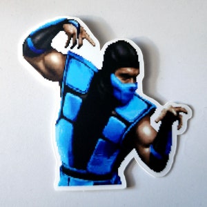 May include: A blue and black pixelated character with a blue mask, wearing a blue and black suit, with a white background.