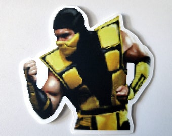 May include: A yellow and black pixelated sticker of a video game character. The character is wearing a yellow and black suit and a black mask. The character is in a fighting pose.