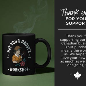 May include: Black coffee mug with the text "NOT YOUR DADDY'S WORKSHOP" and an illustration of a female welder. The mug has a black handle and a floral design. The background is a gradient of green.