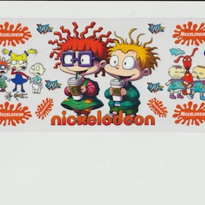 May include: A colorful illustration of the Nickelodeon cartoon characters,  Rugrats, with the text "Nickelodeon" and "90's" on the image. The characters are Tommy Pickles, Chuckie Finster, Phil and Lil DeVille, and Angelica Pickles.