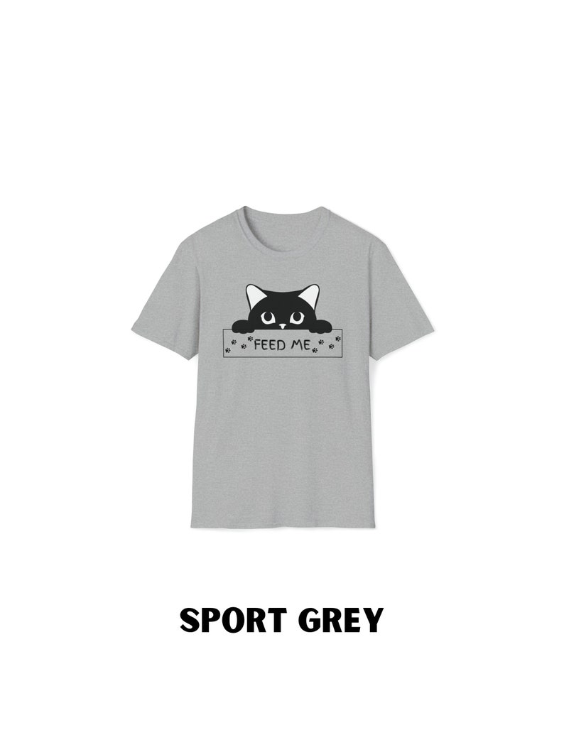 May include: A grey t-shirt with a black cat peeking over a sign that says "FEED ME".