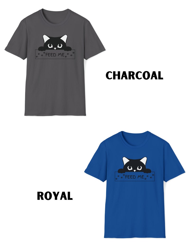 May include: A black cat peeking over a sign that says "Feed Me" with paw prints on either side. The sign is on a charcoal grey t-shirt. The same design is on a royal blue t-shirt.