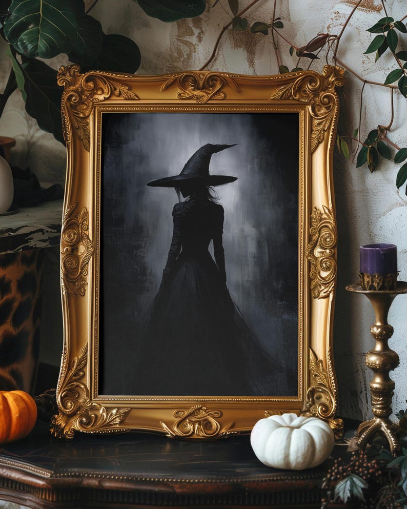 May include: A framed illustration of a witch in a black dress and pointed hat, standing in a dark, foggy forest. The frame is ornate and gold.