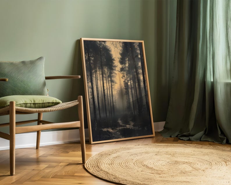 May include: A framed print of a forest scene with tall trees and a path leading into the woods. The print is in a wooden frame and is hanging on a green wall.