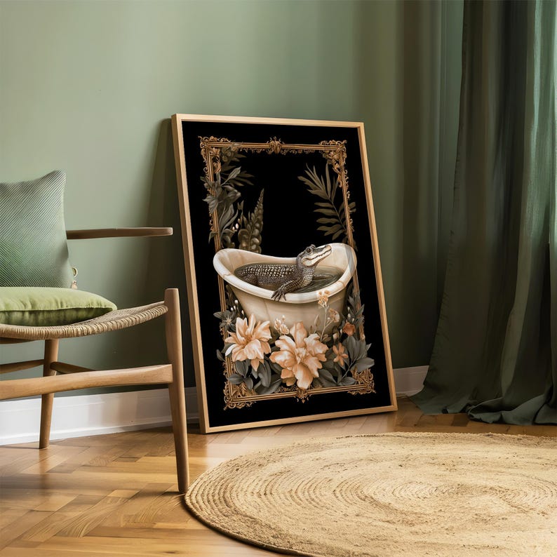 May include: Art print depicting an alligator in a bathtub, set against a black backdrop with a gold frame. The image is adorned with floral and botanical elements. The framed artwork is displayed in a room with a chair and a circular rug.