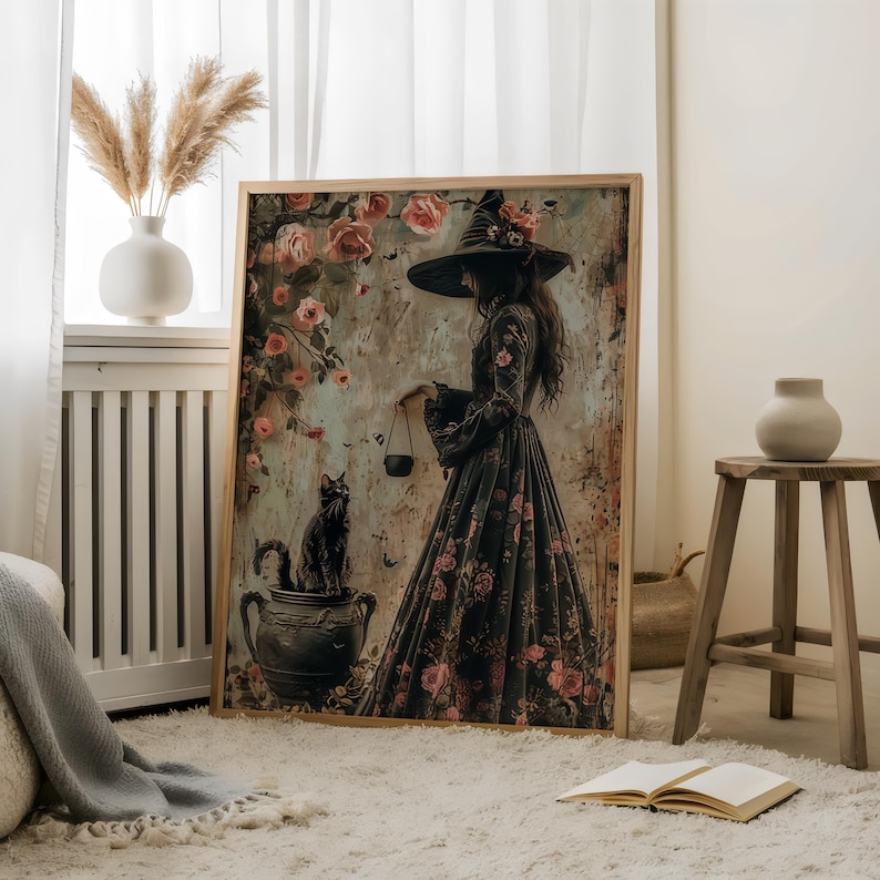 May include: A framed canvas print featuring a woman in a black witch's hat and dress, holding a cauldron. She is surrounded by pink roses and a black cat sits in a pot.