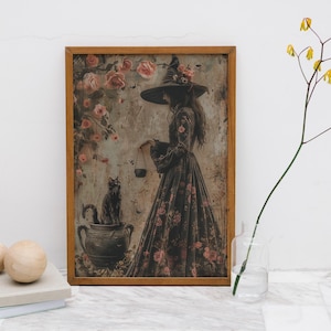 May include: A framed print of a witch in a black dress and a pointed hat, holding a cauldron. The witch is surrounded by pink roses and a black cat sits on a cauldron.