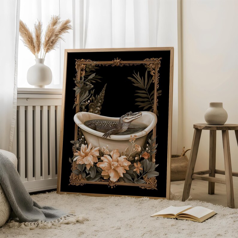 May include: Art print depicting an alligator in a bathtub, set against a black backdrop with a gold frame. The artwork incorporates floral and botanical details in soft colours. The framed print is displayed in a room with natural light and a neutral colour palette.