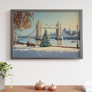 May include: A framed painting of a snowy scene with Tower Bridge in London, England. A Christmas tree stands in the foreground with a couple walking by.