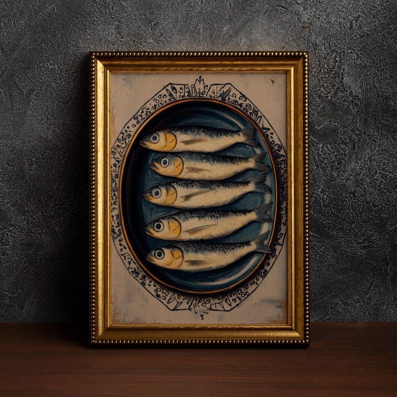 May include: A framed print of a still life painting depicting a blue and white plate with five silver fish arranged in a row. The plate is on a white background with a gold frame.