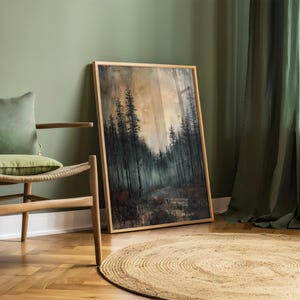 May include: A framed painting of a forest scene with tall trees and a misty background. The painting is in a wooden frame and is hanging on a green wall.